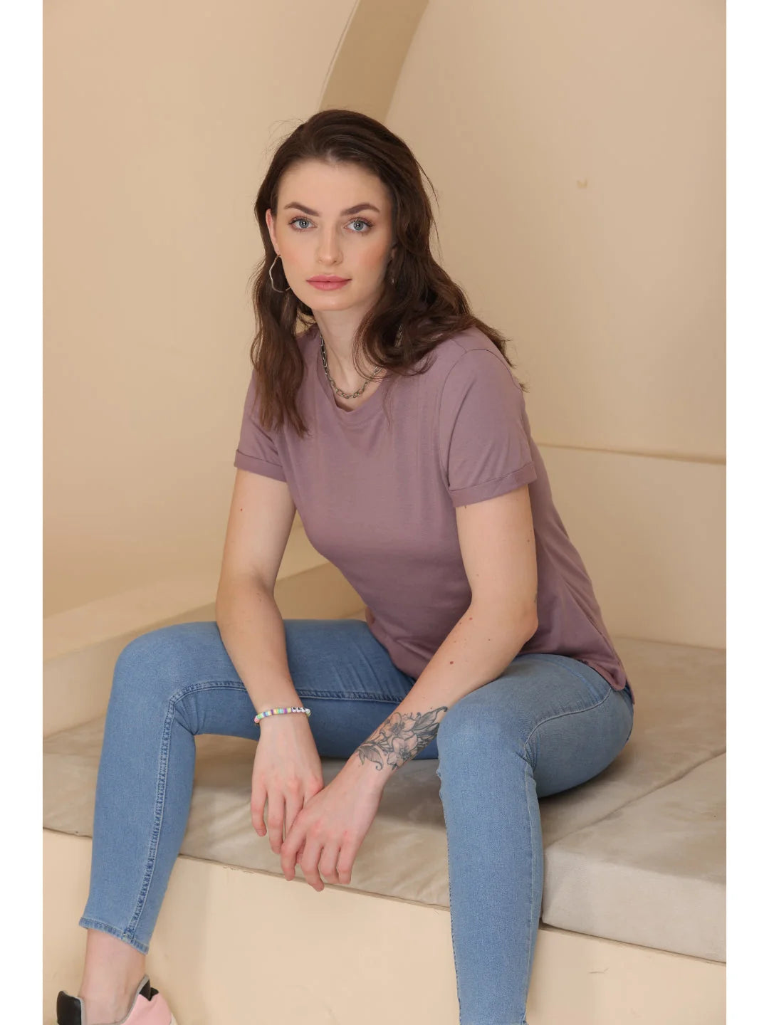 Bronze plain t shirts for women sitting relaxed pose 